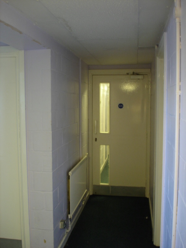 So, we're standing in the corridor. You can see another door blocking your way. We pass a toilet, bathroom and shower.