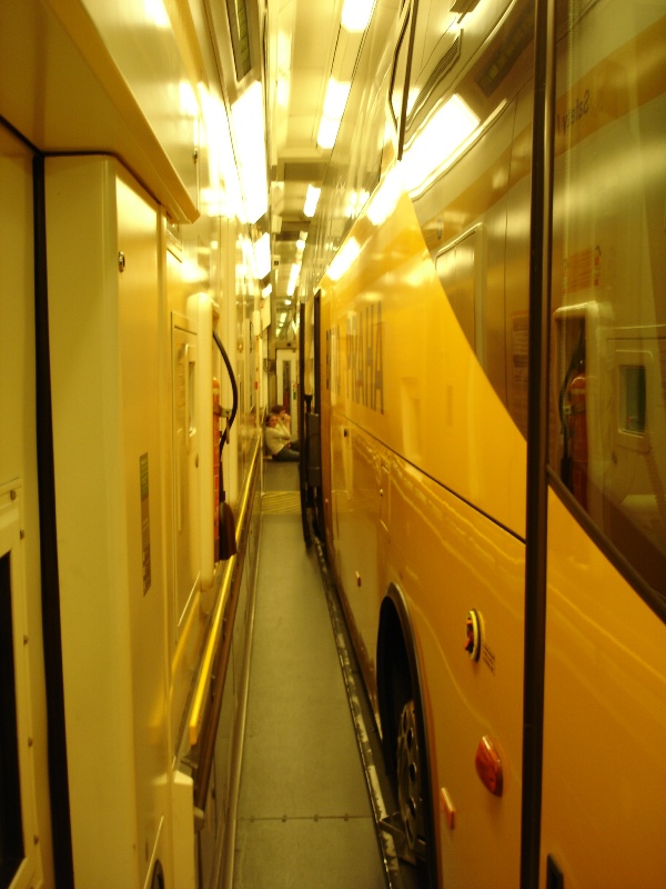 Yes, the coach fits perfectly. You can hardly walk between the bus and the train's walls.
